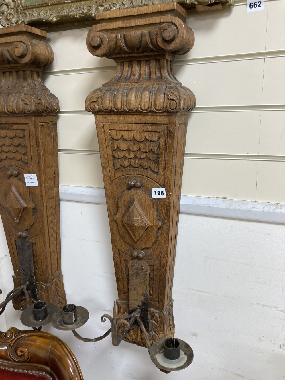A pair of oak and iron wall sconces, height 88cm